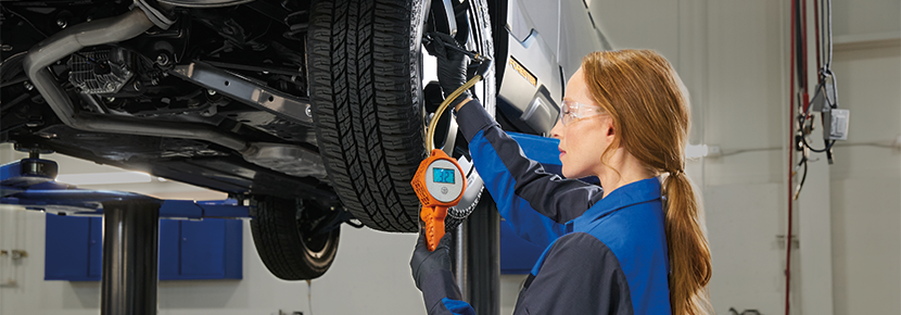 A Subaru technician checking tire pressure. | Subaru World of Hackettstown in Hackettstown NJ