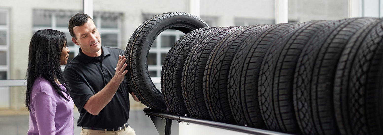 Subaru service representative showing customer a tire. | Subaru World of Hackettstown in Hackettstown NJ