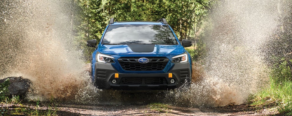 A 2023 Outback Wilderness driving on a muddy trail. | Subaru World of Hackettstown in Hackettstown NJ