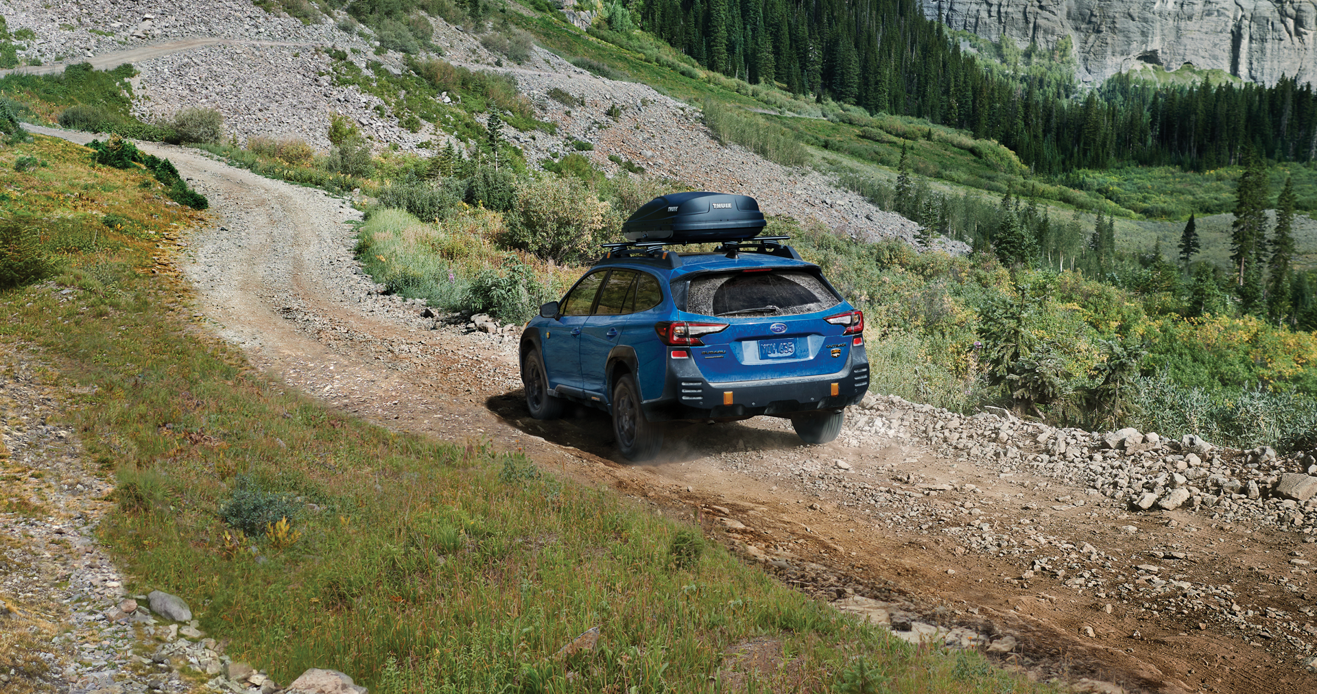 A 2023 Outback Wilderness driving on a trail in the mountains. | Subaru World of Hackettstown in Hackettstown NJ