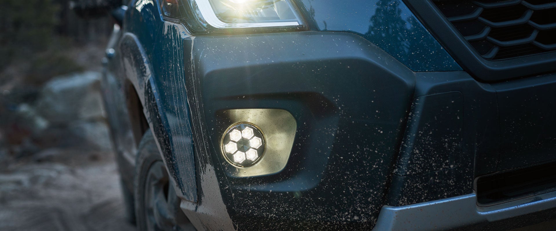 Close-up of right headlight turned on at night